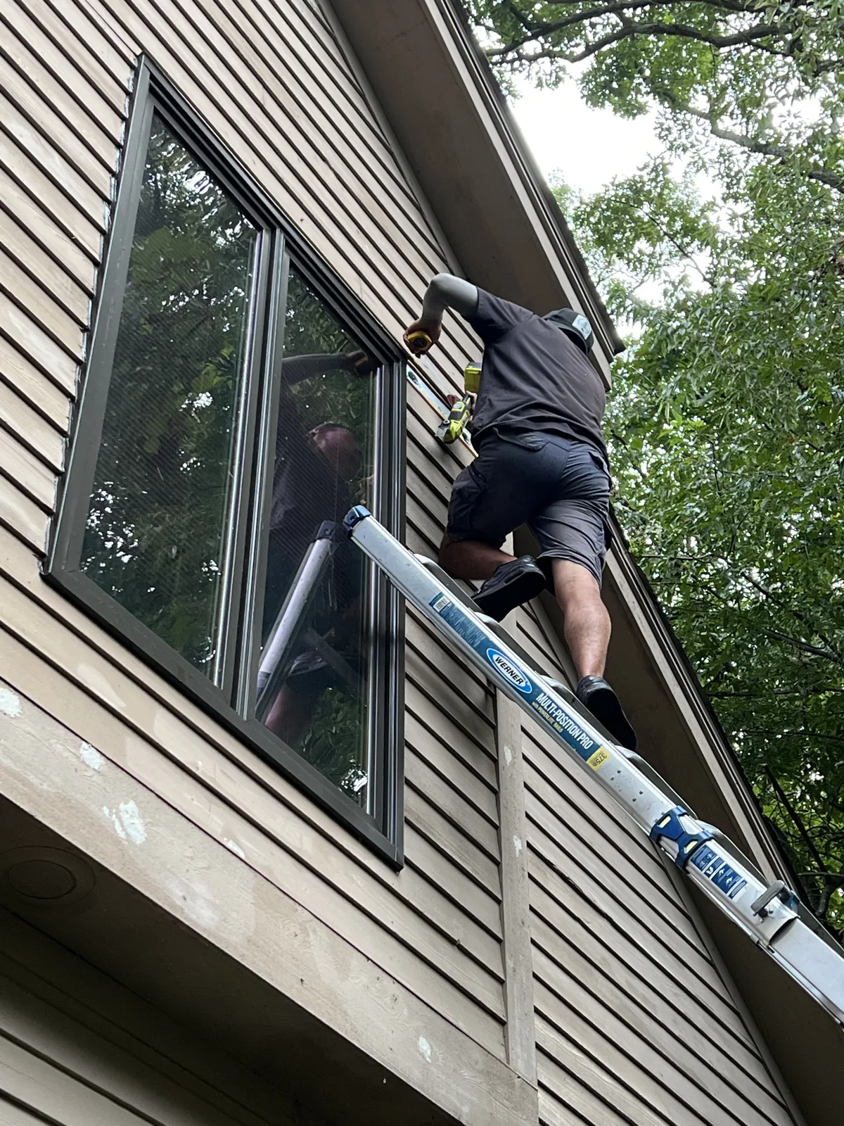 Exterior window and trim work from a ladder